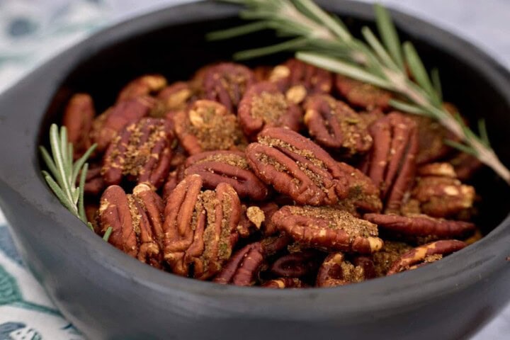 a centered close-up bowl of rosemary spiced pecans