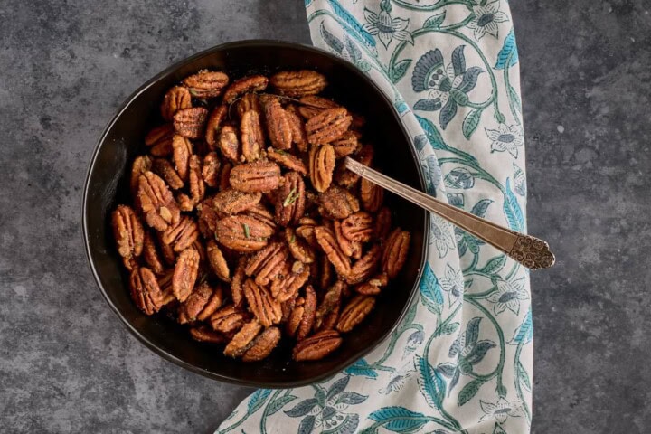 mixing spices with nuts in a bowl with a spoon