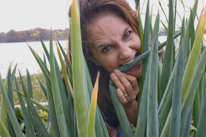 the author in the garden pretending to eat an onion stalk