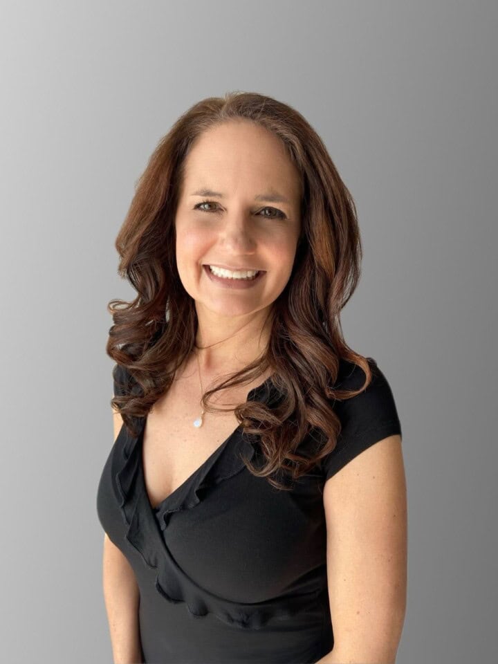 a photo of the author in a black top with a gray background