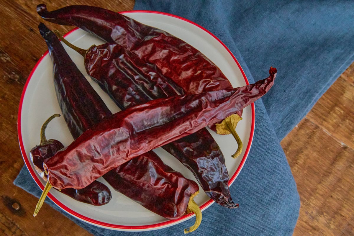 dried numex big jim peppers on a plate atop a napkin