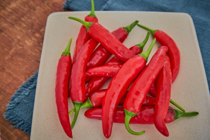 fresh korean hong gochu peppers on a plate atop a napkin