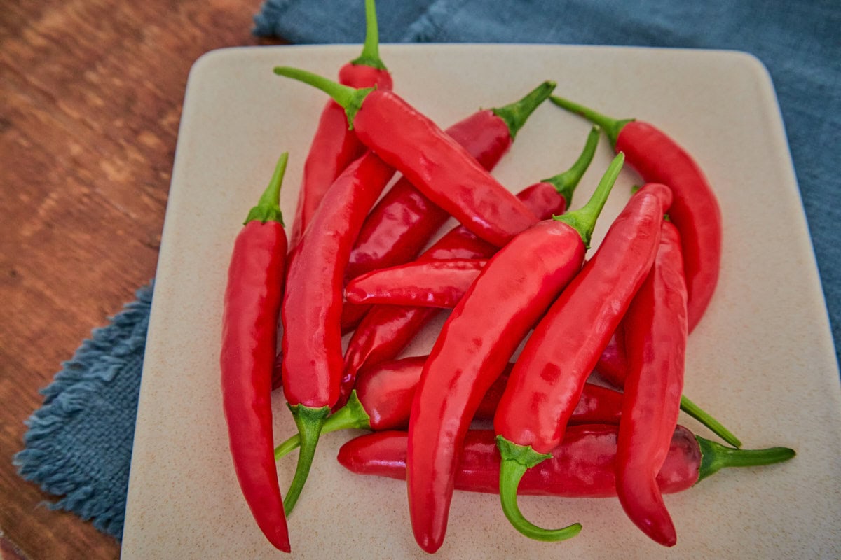 fresh korean hong gochu peppers on a plate atop a napkin