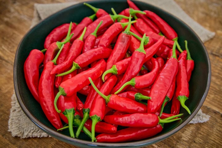 fresh korean hong gochu peppers in a bowl atop a napkin