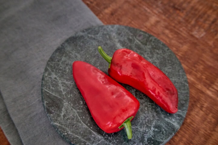 fresh leutschauer paprika peppers on a stone tray atop a napkin