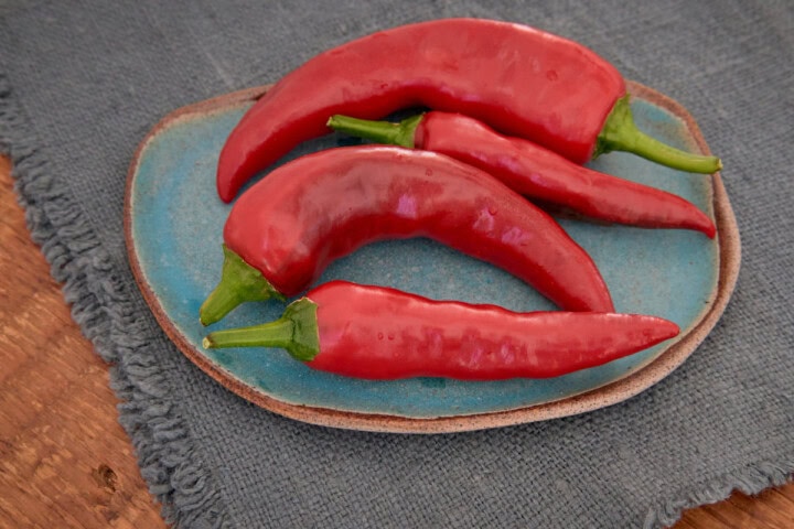 fresh szeged peppers on a plate atop a napkin