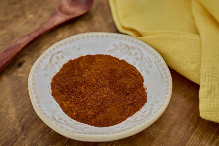 beaver dam pepper powder in a small bowl with a wooden spoon and a napkin in the background