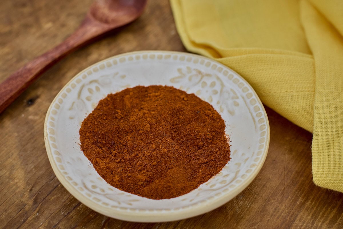 beaver dam pepper powder in a small bowl with a wooden spoon and a napkin in the background