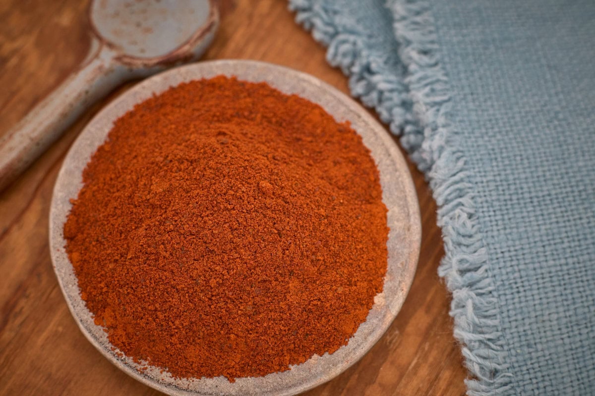 numex big jim powder in a small bowl with a ceramic spoon and a napkin alongside