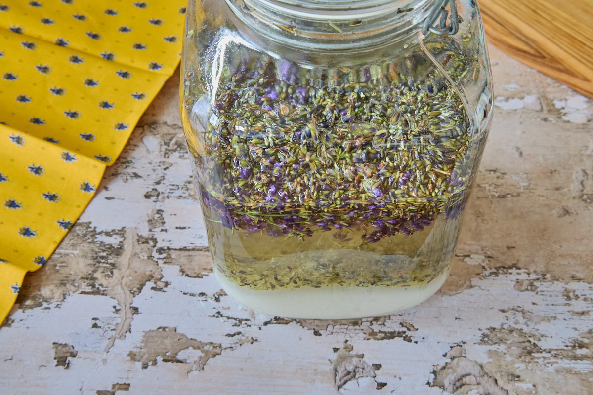 a jar of lavender liqueur ingredients, napkin, and wooden board