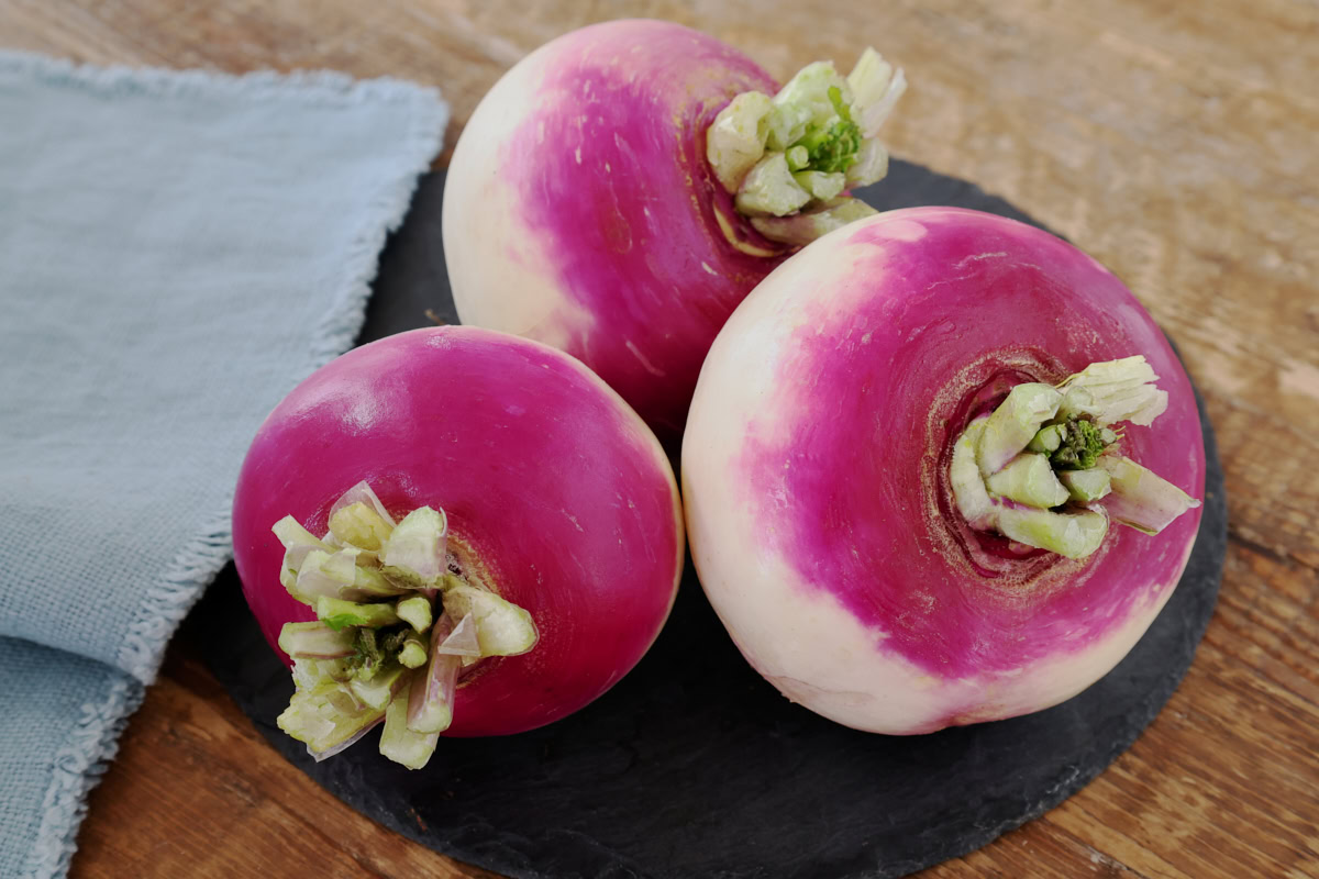 freshly picked platte witte mei turnips on a stone tray with a napkin alongside